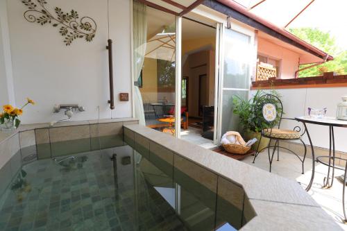 a swimming pool in a house with a patio at 小さなホテルセラヴィ in Nagatoro