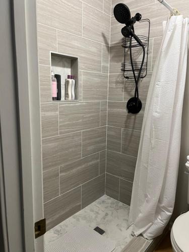 a bathroom with a shower with a shower curtain at Mar town house in Smyrna