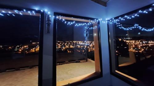 a room with a view of a city with lights at Refugio del Pescador in Esquel