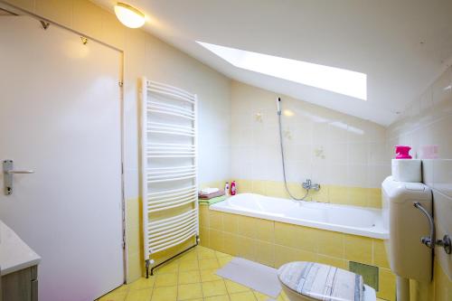 a bathroom with a bath tub and a sink at Oaza udobja s čudovitim razgledom in Oplotnica