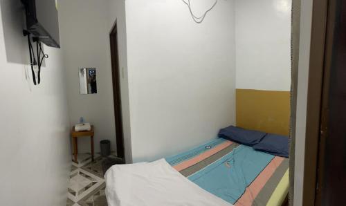 a small room with a bed and a swimming pool at Calo Apartel in Panabo