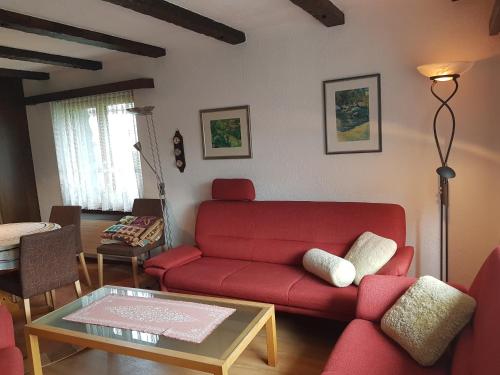 a living room with a red couch and a table at Stgirat (356 Ac) in Valbella
