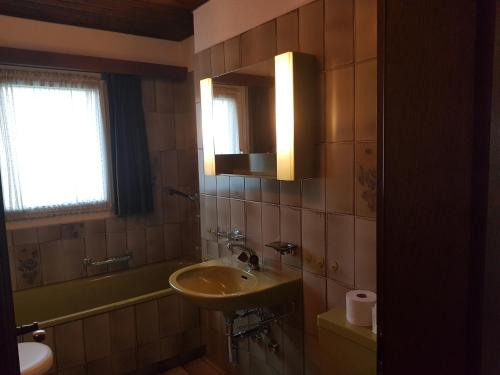 a bathroom with a sink and a mirror at Stgirat (356 Ac) in Valbella
