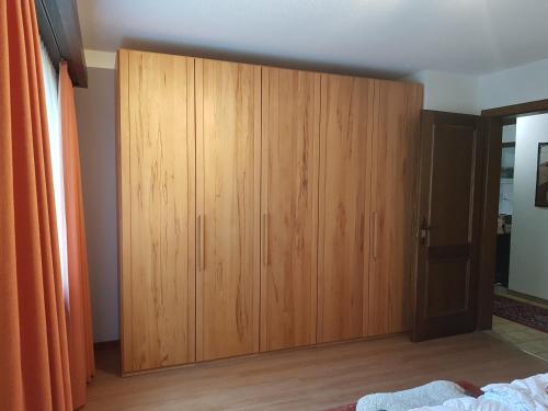 a wooden cabinet in the corner of a bedroom at Stgirat (356 Ac) in Valbella