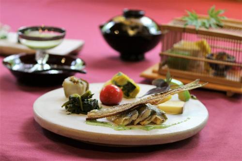 a plate of food on a pink table at 小さなホテルセラヴィ in Nagatoro