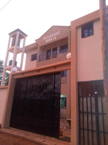 a building with a black gate in front of it at Residence Mindja in Yaoundé