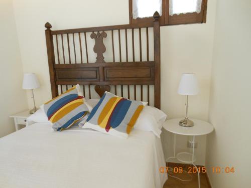a bedroom with a bed with two tables and two lamps at Nanfro Resort - Masseria Spaccaforno in Caltagirone