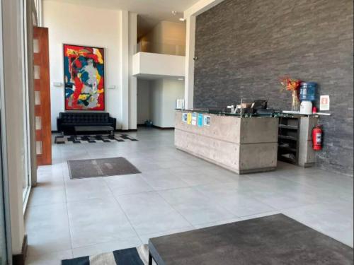a lobby with a reception desk in a building at 8 Apartamento en Santiago en fente al Metro - Hipodromo de Chile y Estadio San Laura in Santiago