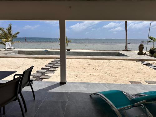 a view of the beach from a house with chairs at Pension Irivai, Appartement RAVA 1 chambre bord de mer in Uturoa
