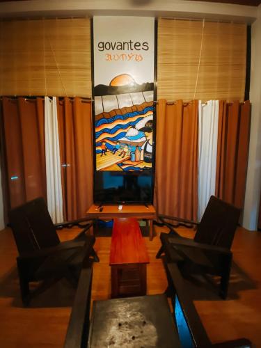 a room with two chairs and a large screen at The Bistro House - Loft Unit - Vigan in Vigan