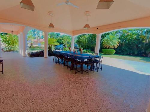 a dining room with a blue table and chairs at Luxury Villa Classic style, 7 minutes from the beach in Sosua in San Felipe de Puerto Plata
