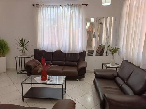 a living room with a couch and a table at Luxury Villa Classic style, 7 minutes from the beach in Sosua in San Felipe de Puerto Plata