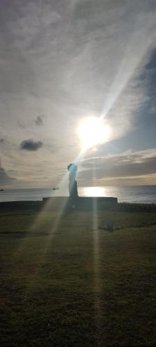 a person is standing in front of the sun at Villa Maori Tea Rapa Nui, Easter Island with ocean view in Hanga Roa
