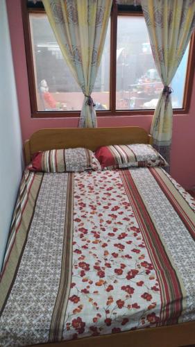 a bed in a bedroom with a window at CASA JEI in Iquitos