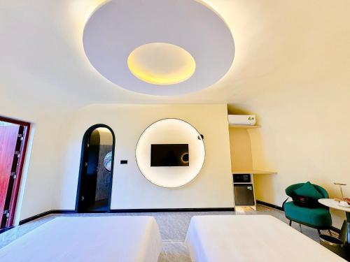 a room with two beds and a mirror at Moc Chau Island - Bach Long Glass Bridge in Mộc Châu