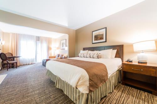 a hotel room with a large bed and a desk at Horseshoe Valley Suites - The Maple in Shanty Bay
