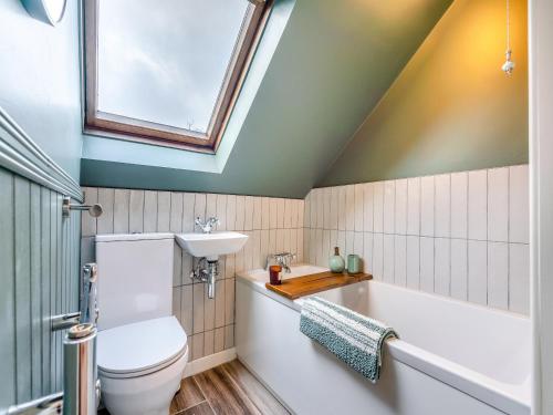 a bathroom with a toilet and a sink and a bath tub at Highbury in Rothbury