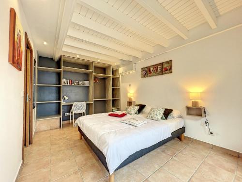 a bedroom with a large bed in a room at Terrathely in Le Moule