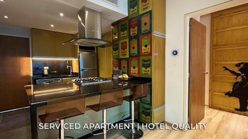 a kitchen with a counter with a stove in it at Serviced Apartment Pretty Penthouse Valencia in Valencia
