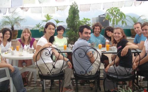 a group of people sitting at tables in a restaurant at Avalon House in Kathmandu
