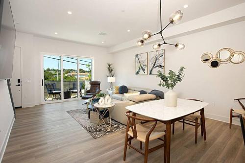 a living room with a table and a couch at Luxury NEW Residence with Private Rooftop, Downtown in minutes in San Diego