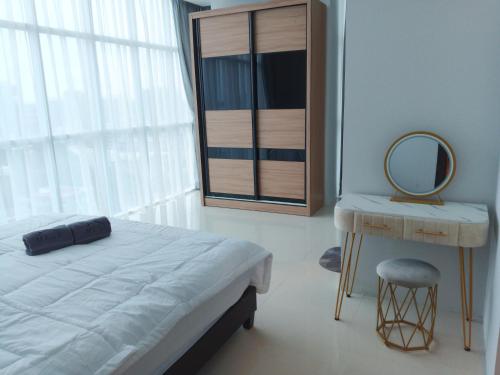 a bedroom with a bed and a mirror and a table at Formosa Spacious Apartments with Netflix & Pick Up Service by MESA in Nagoya