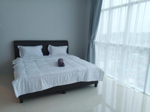 a teddy bear sitting on a bed in a bedroom at Formosa Spacious Apartments with Netflix & Pick Up Service by MESA in Nagoya