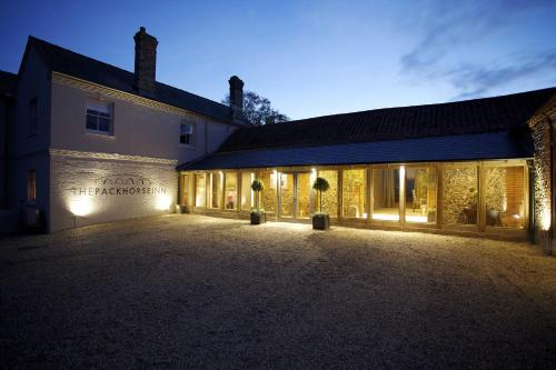 un edificio illuminato di notte con luci di The Packhorse Inn a Newmarket