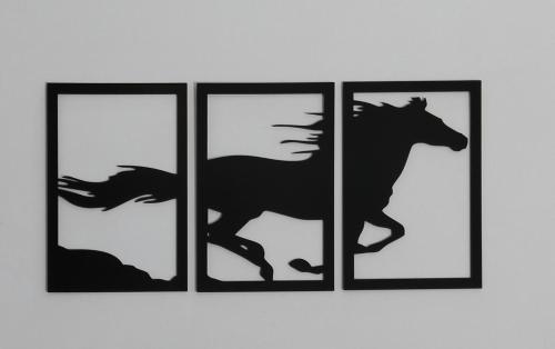 four framed silhouettes of horses on a wall at Homewood Suites Family Guest House & Apartments in Lahore