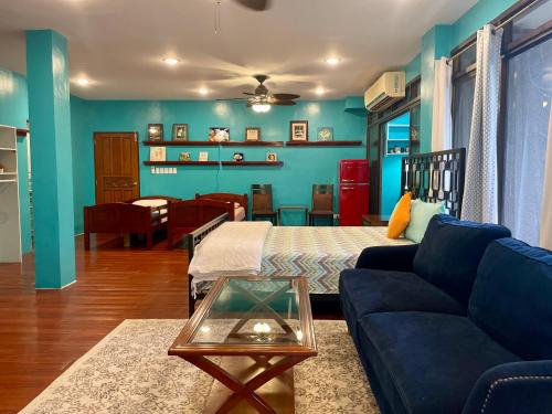 a living room with a bed and a couch at Ngermid Oasis-XL Studio With Kitchen & Scenic Views in Koror