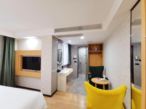 a hotel room with a bed and a bathroom at Connar Hotel - Shenzhen Futian in Shenzhen