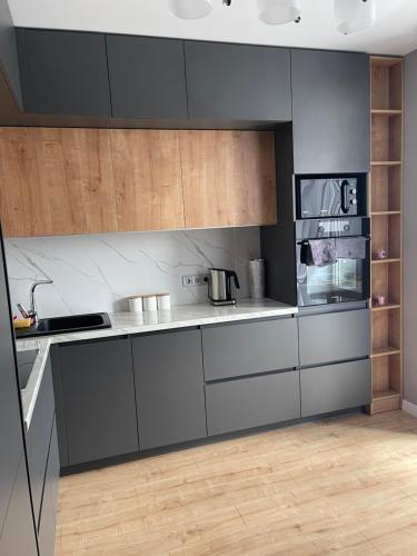 a kitchen with gray cabinets and wooden counters at VIP квартира в центре города, новостойка в ЖК Prestige Apаrtments, Ровно in Rivne