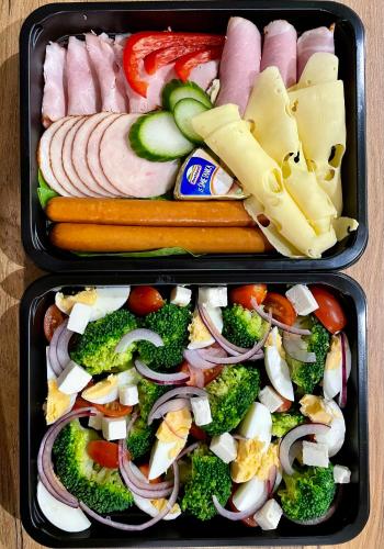 two trays of food with vegetables and meats at Stodoła Na Kresach - widokowy domek drewniany, całoroczny JACUZZI & SAUNA in Bodzentyn