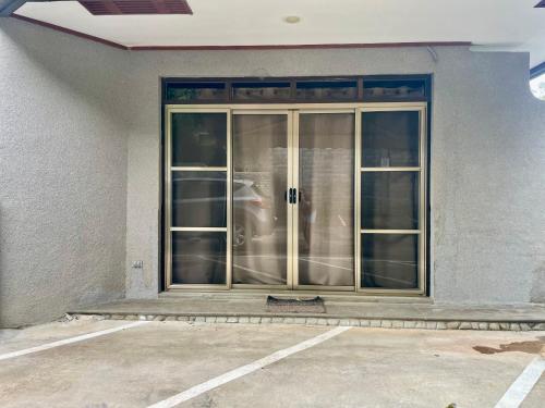 a large glass door of a building at Ngermid Oasis-XL Studio With Kitchen & Scenic Views in Koror