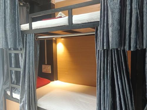 a bedroom with two bunk beds in a room at MY DORMITORY in Mumbai