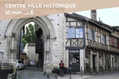 a person sitting in front of a building at La Barbotine - Cosy - Centre ville in Bourg-en-Bresse