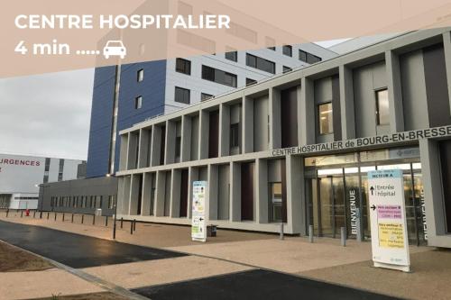 a building with a hospital with a sign in front of it at La Barbotine - Cosy - Centre ville in Bourg-en-Bresse