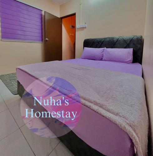 a bedroom with a purple bed with the words nunas homepage at Nuha's Homestay Teluk Intan in Teluk Intan