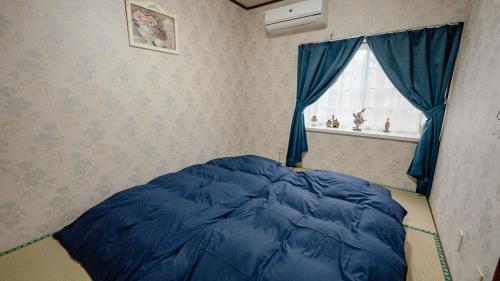 Ένα ή περισσότερα κρεβάτια σε δωμάτιο στο AMAMI-Green-Garden