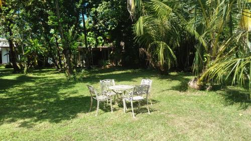 a table and chairs sitting in the grass at Madampa Ganga Villa. in Ambalangoda