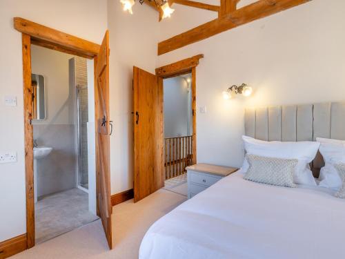 um quarto com uma cama grande e uma casa de banho em Garden Cottage - Uk45498 