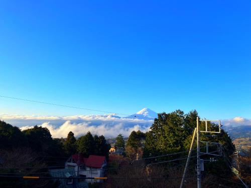 a view of a mountain with clouds in the background at 南箱根 熱海 貸切別荘 リゾートハウス トモ in Atami