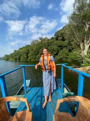 a woman standing on a boat on the water at Mount View in Polonnaruwa