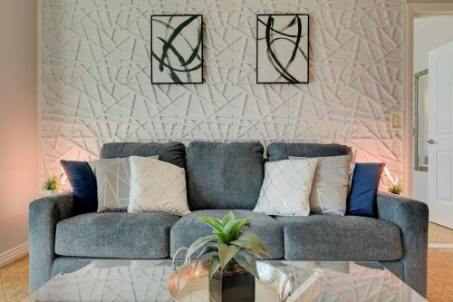 a blue couch in a living room with a wall at Serenity Suite at MGM Signature in Las Vegas