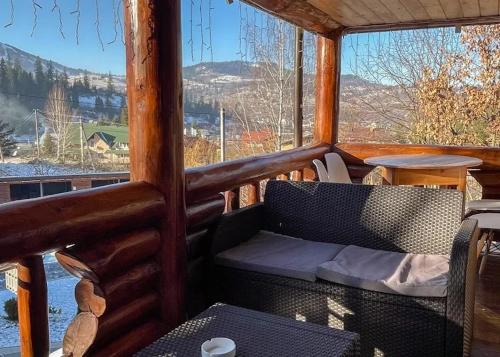 a screened in porch with a couch and a table at Provence in Slavske