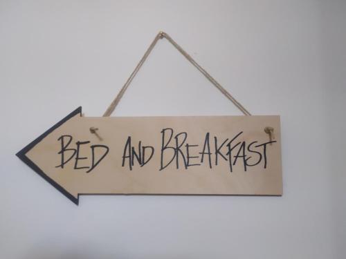 a sign that reads bed and breakfast hanging on a wall at Il Giramondo in Montelabbate