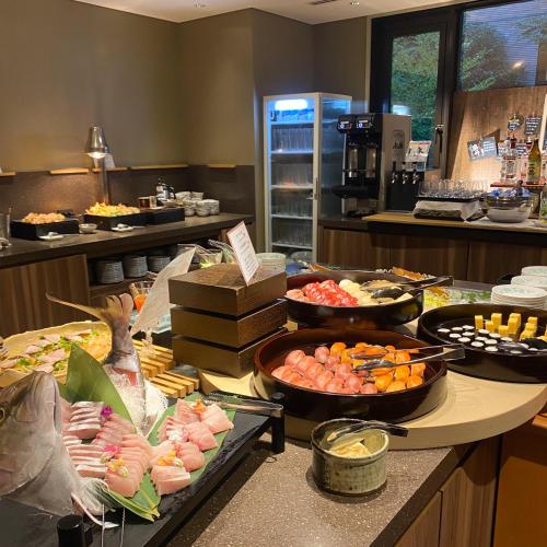 a buffet with many different types of food on a counter at Hakone Yutowa in Hakone