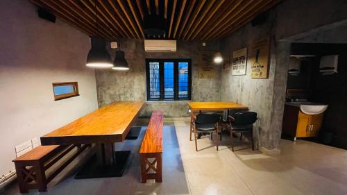 a dining room with two wooden tables and chairs at SOLO INN in Cochin