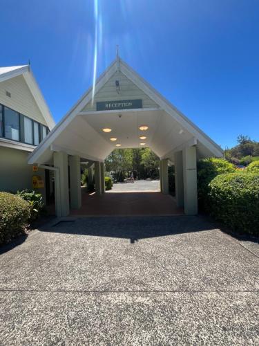 a building with a garage with a sign on it at Poppies Lakeview Terrace - 2 Bedroom in Cams Wharf