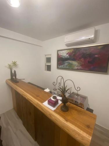 a wooden desk in a room with a painting on the wall at 鳳凰懷舊 in Chenggong